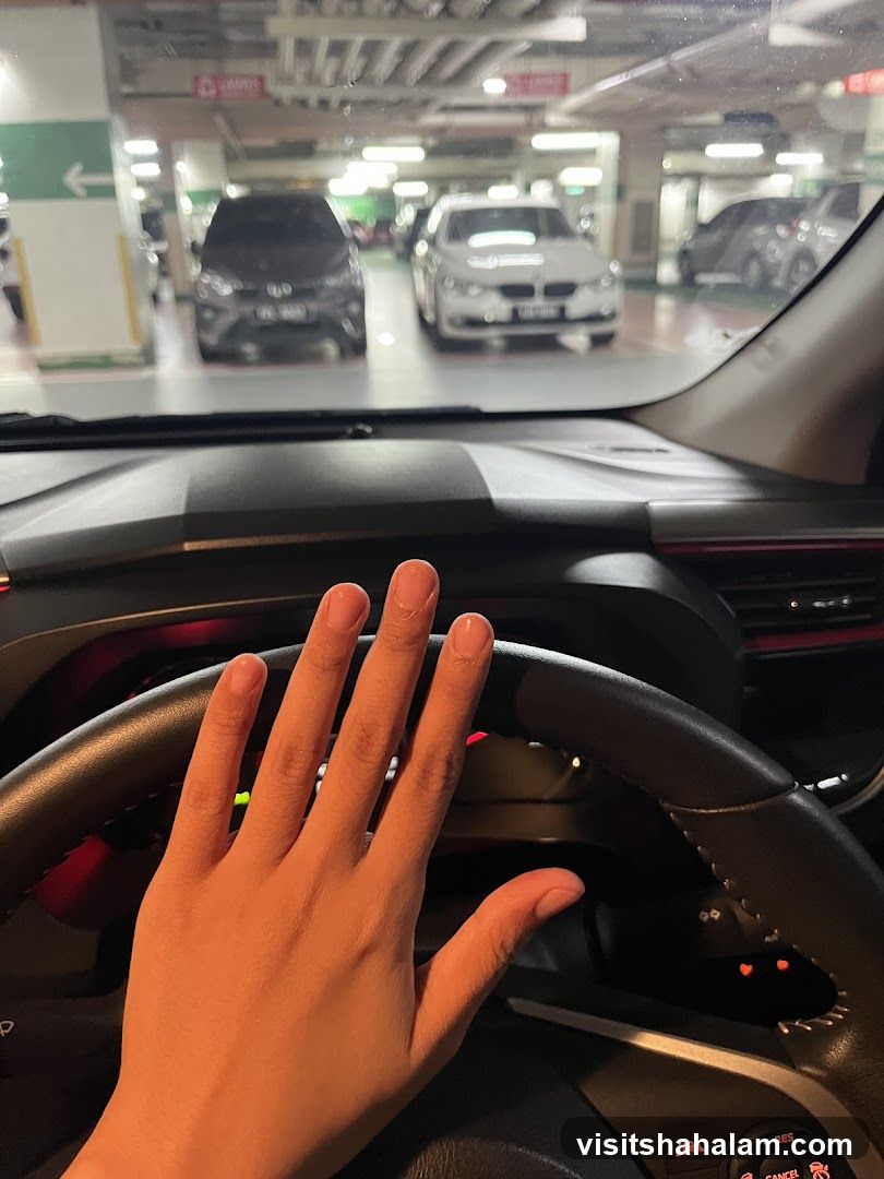 Hand on Steering Wheel in Parking Garage