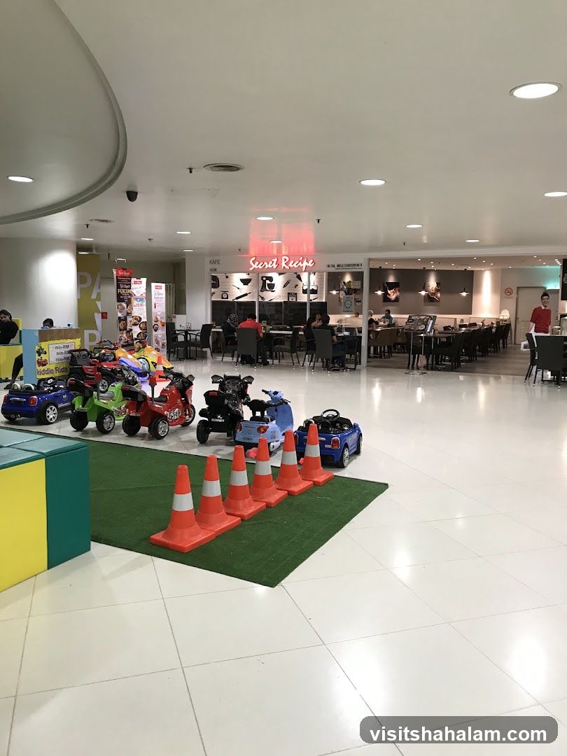 Indoor play area with toy cars and a cafe