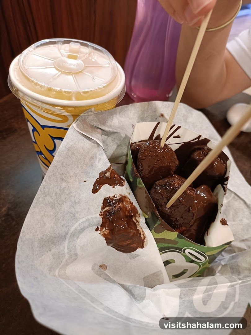Chocolate-covered donut holes and a drink