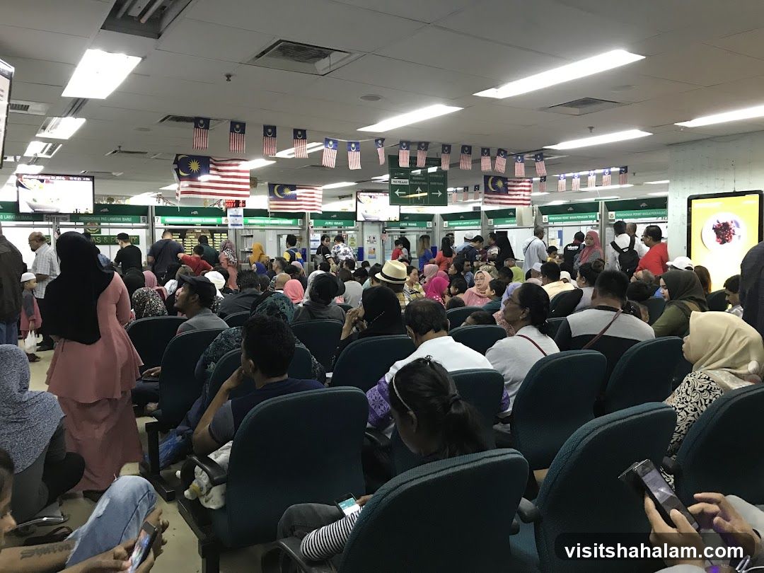 Crowded Waiting Area with Malaysian Flags