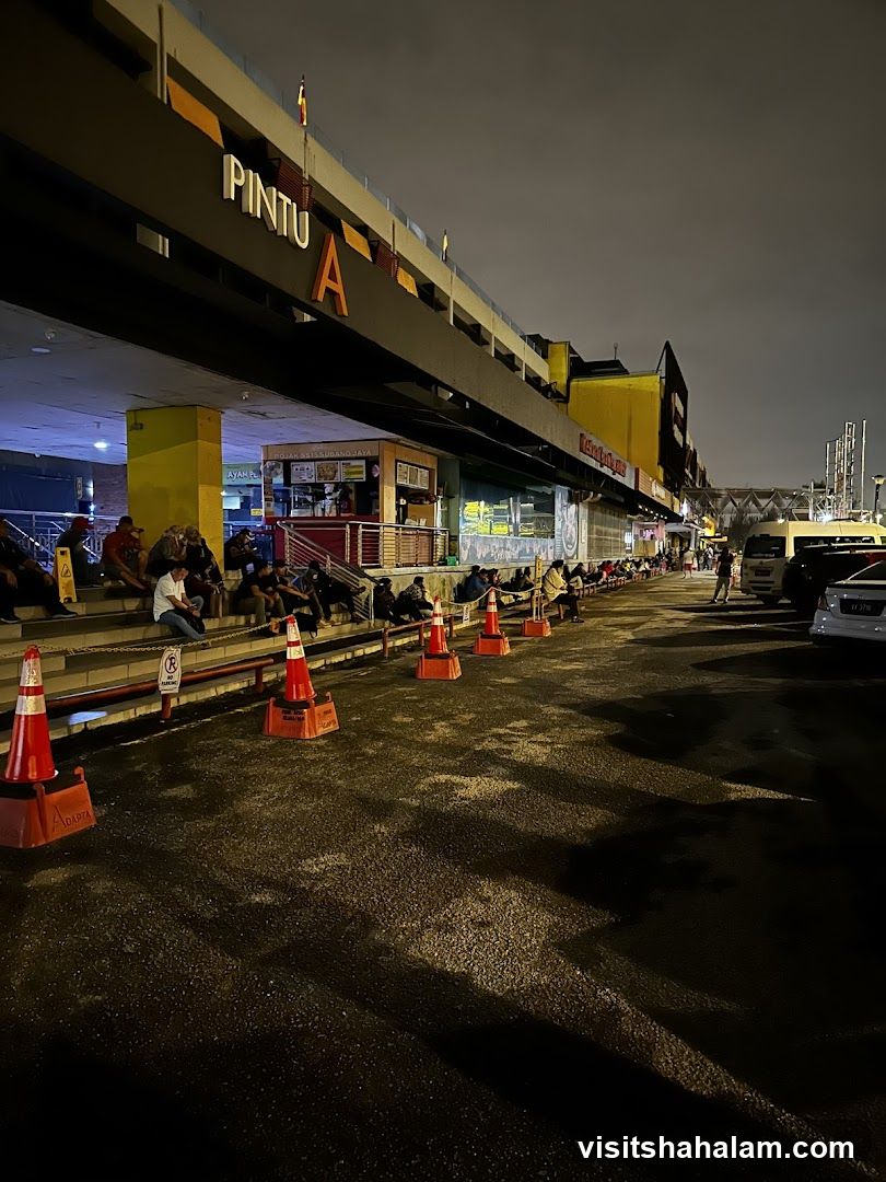Nighttime scene with people queuing