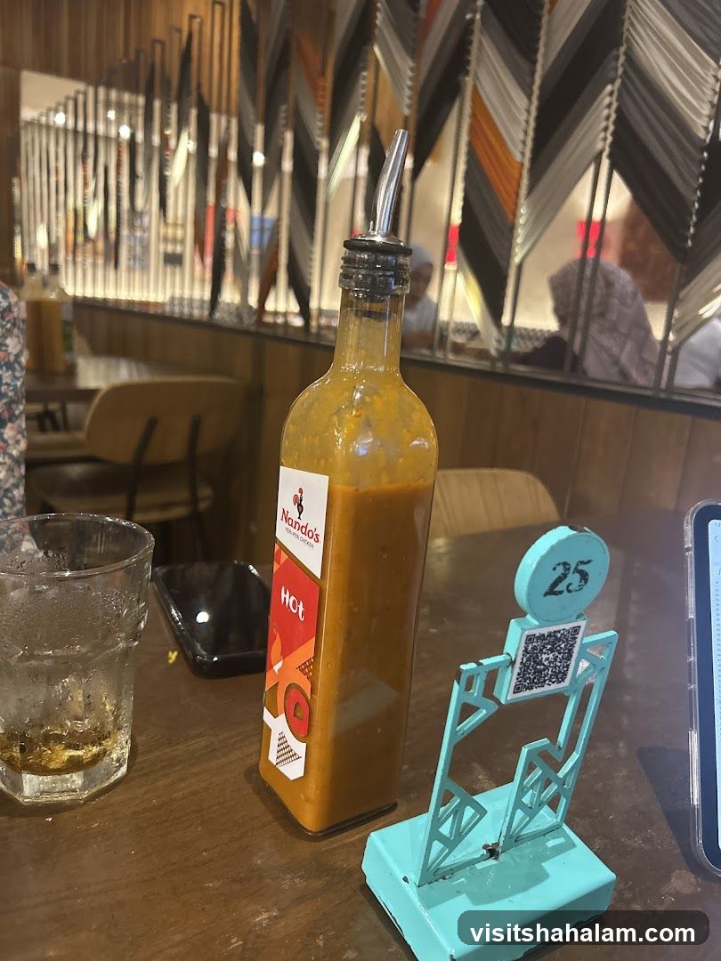 Nando's Hot Sauce Bottle on Table