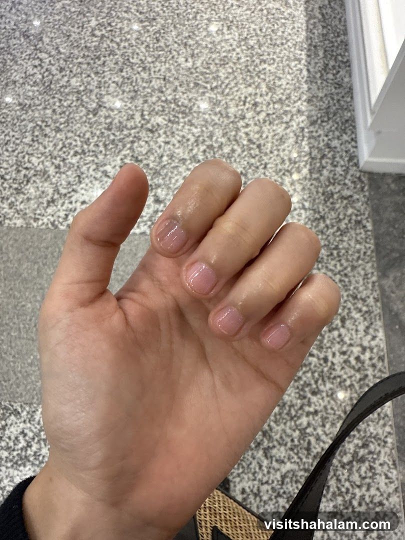 Hand with light pink nails