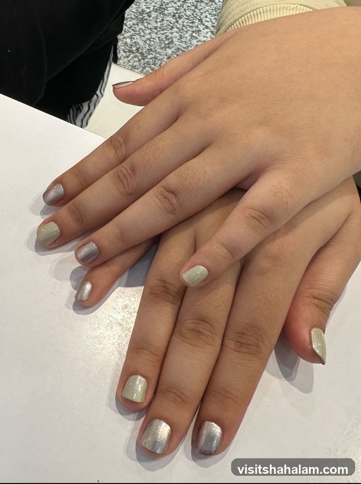 Two hands with manicured nails