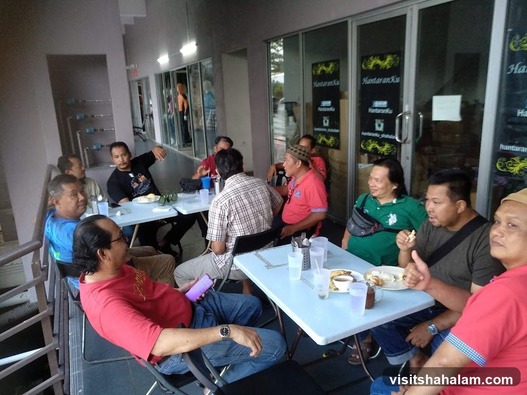 Group of men eating at tables
