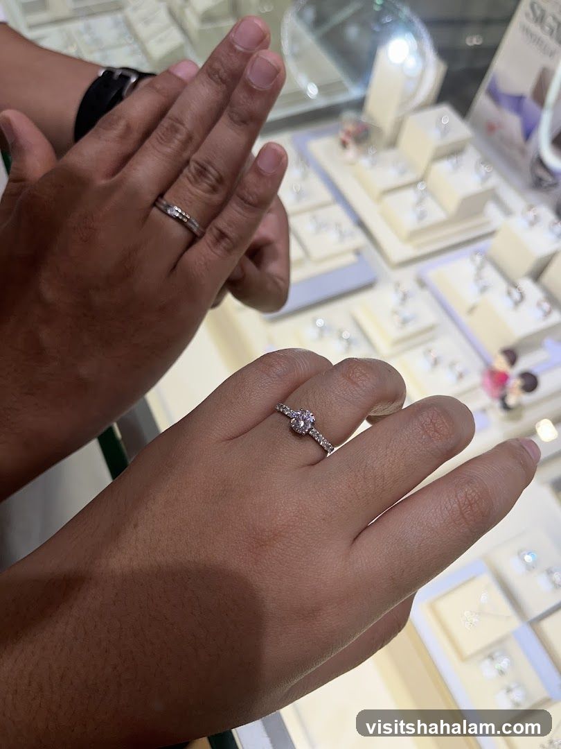 Hands wearing rings in a jewelry store