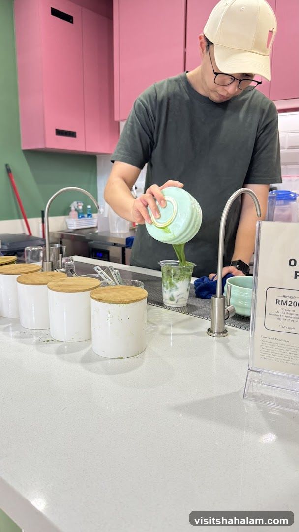 Barista preparing a matcha drink