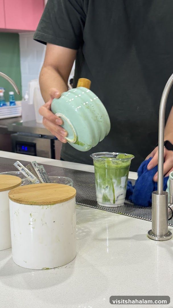 Barista preparing a matcha drink