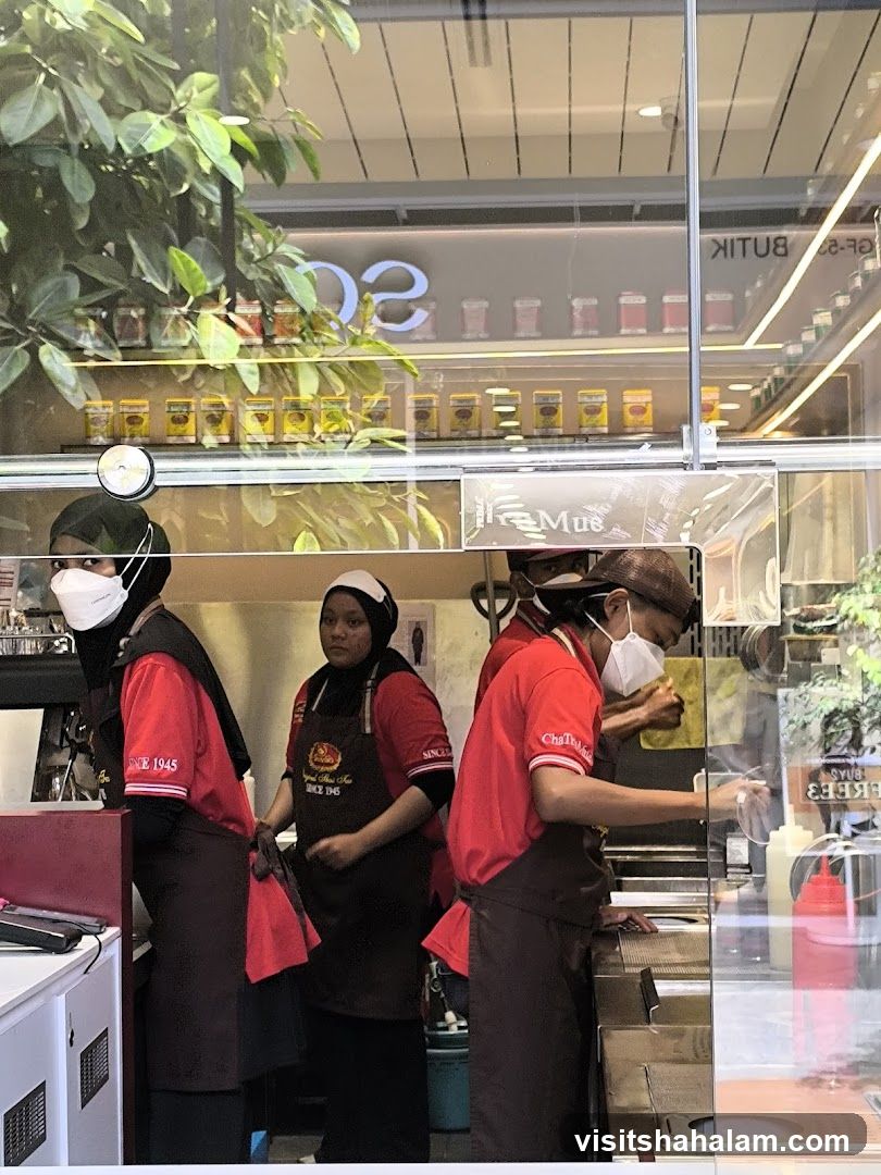 Staff preparing food behind a counter
