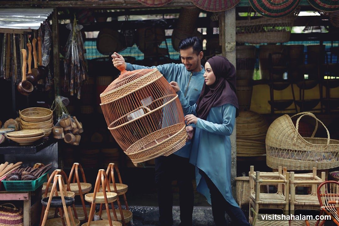 Couple examining a large birdcage at a market stall