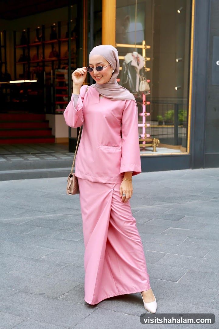 Woman in pink outfit posing outside a store