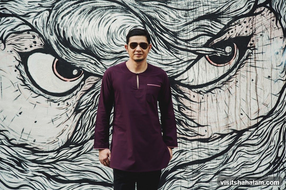 Man Posing in Front of Graffiti Art