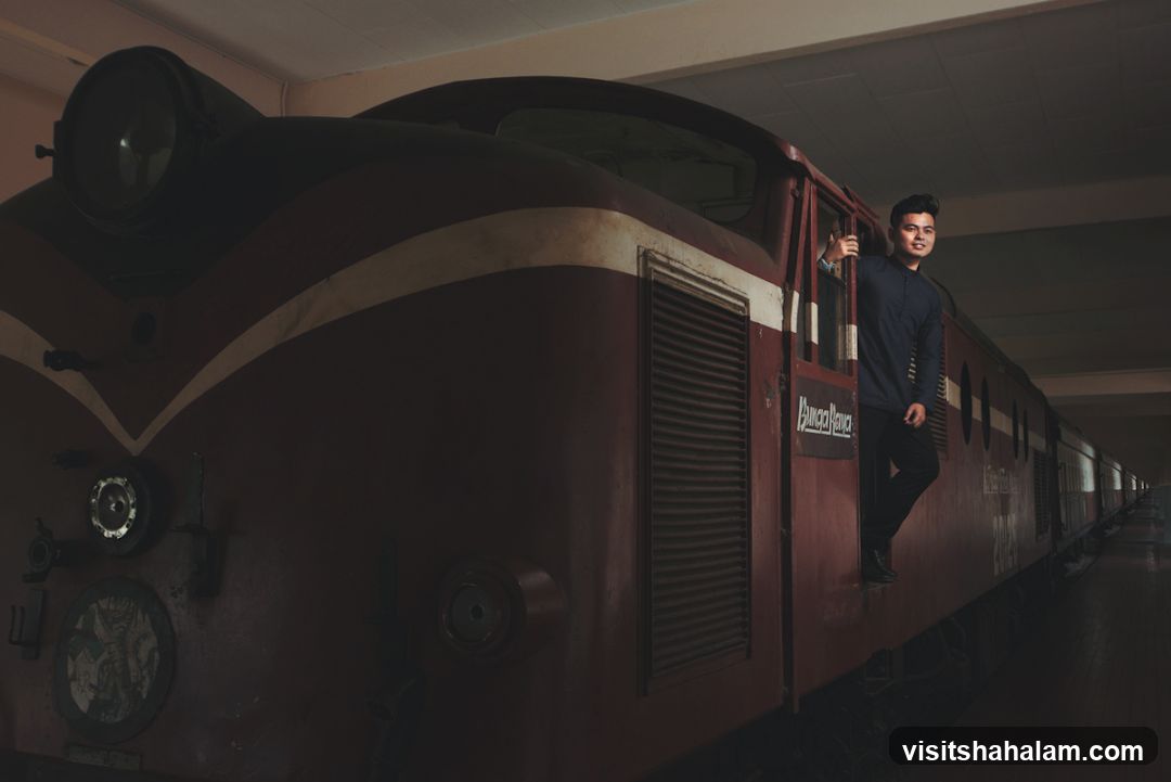 Man posing by a train