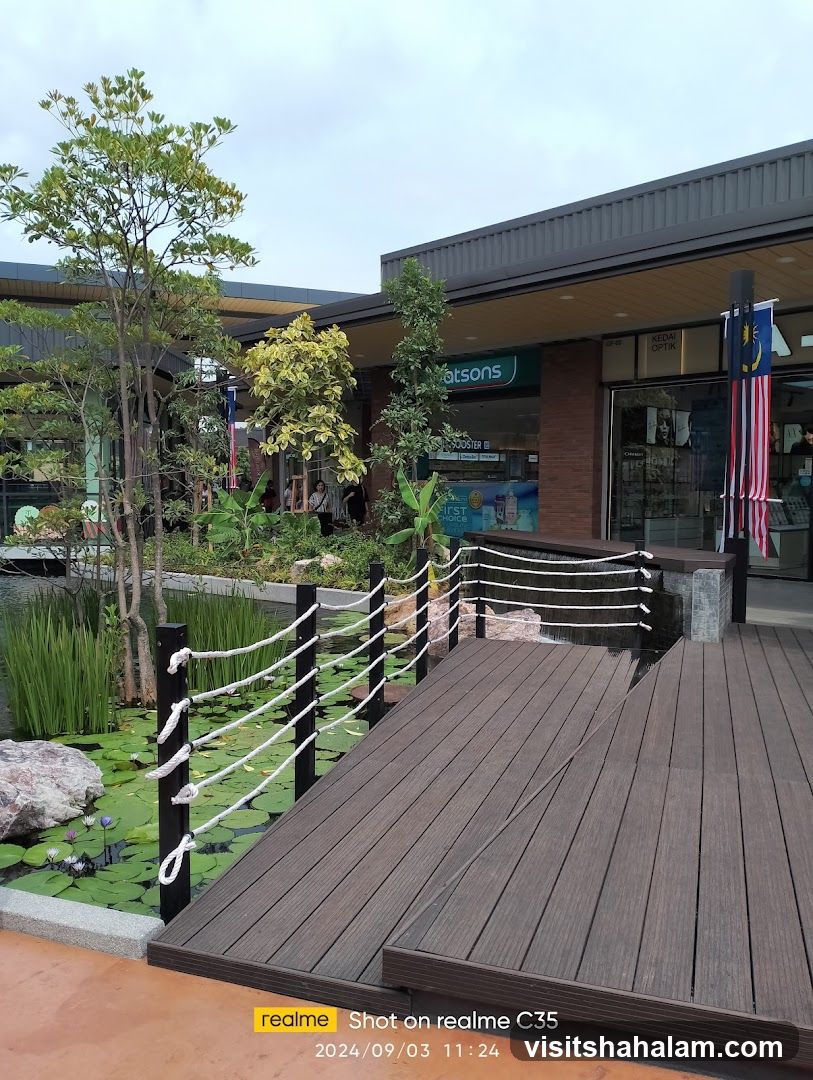 Outdoor walkway with pond and shops