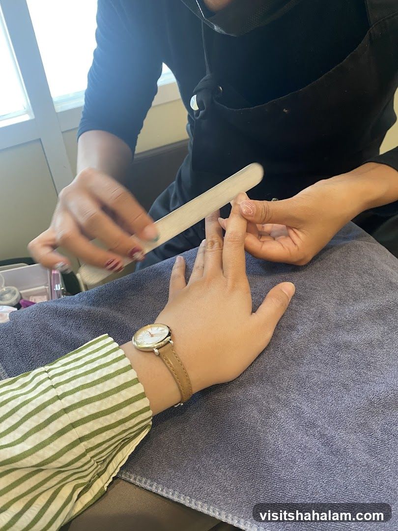 Manicurist Filing Client's Fingernail