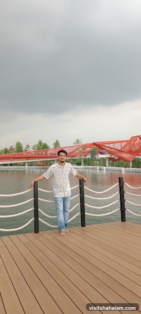 Man on a wooden deck by a lake