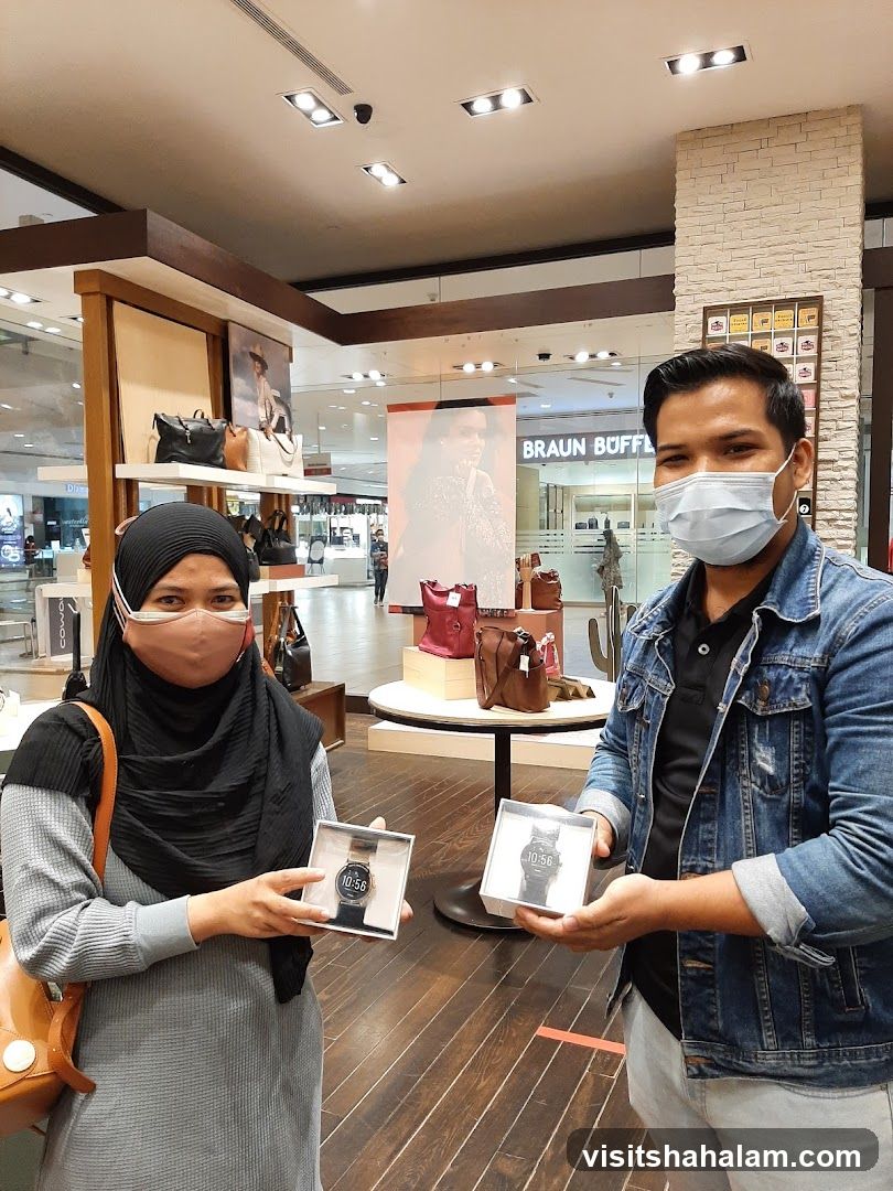 People holding watches in a store