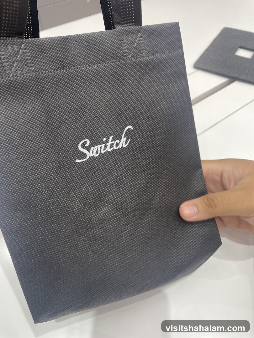 Black tote bag with "Switch" logo
