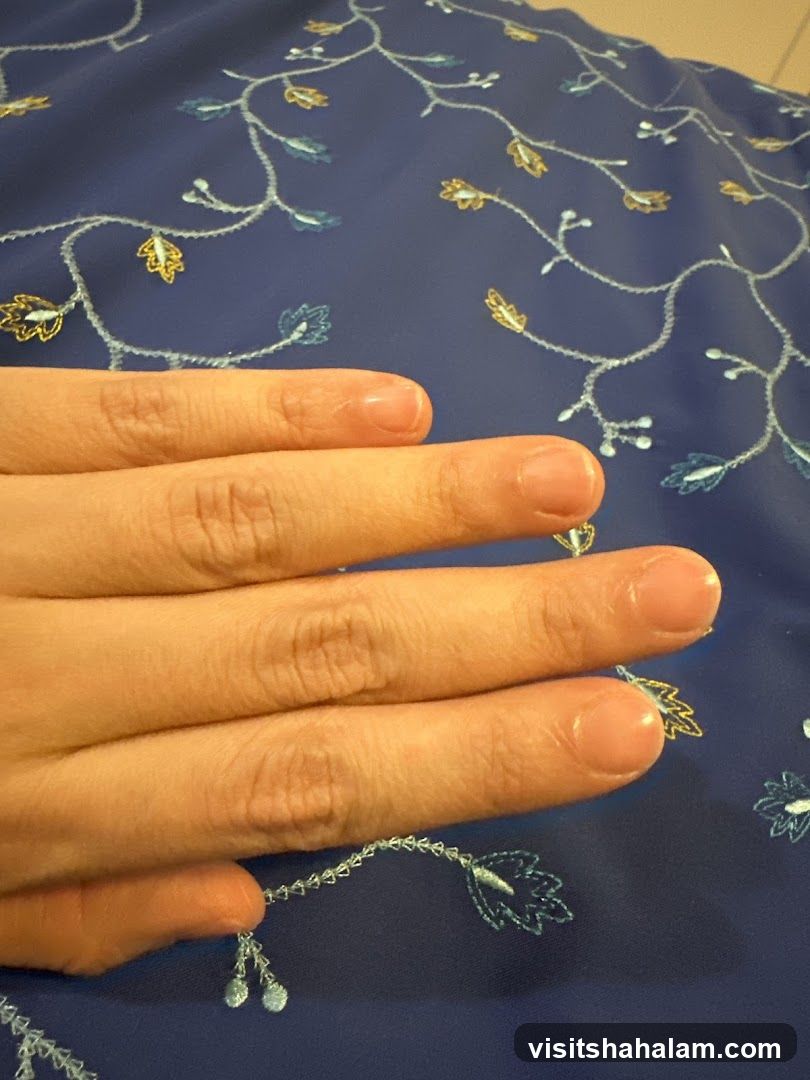 Hand over embroidered fabric