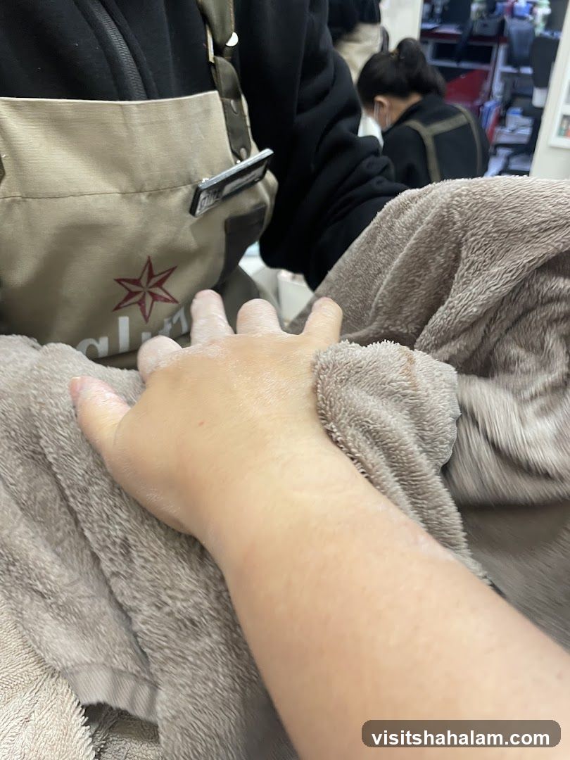 Hand being dried with a towel