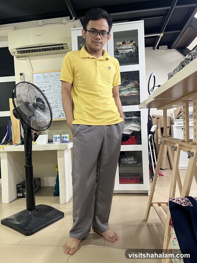 Man in yellow polo shirt and grey pants