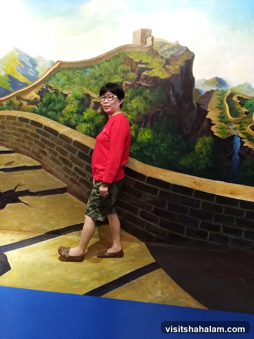 Woman Poses in front of Great Wall of China Mural