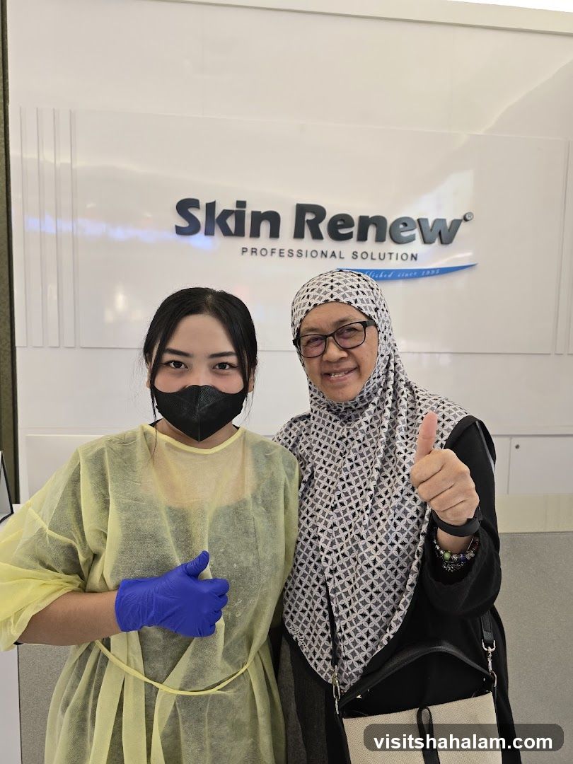 Two women posing in front of a Skin Renew sign