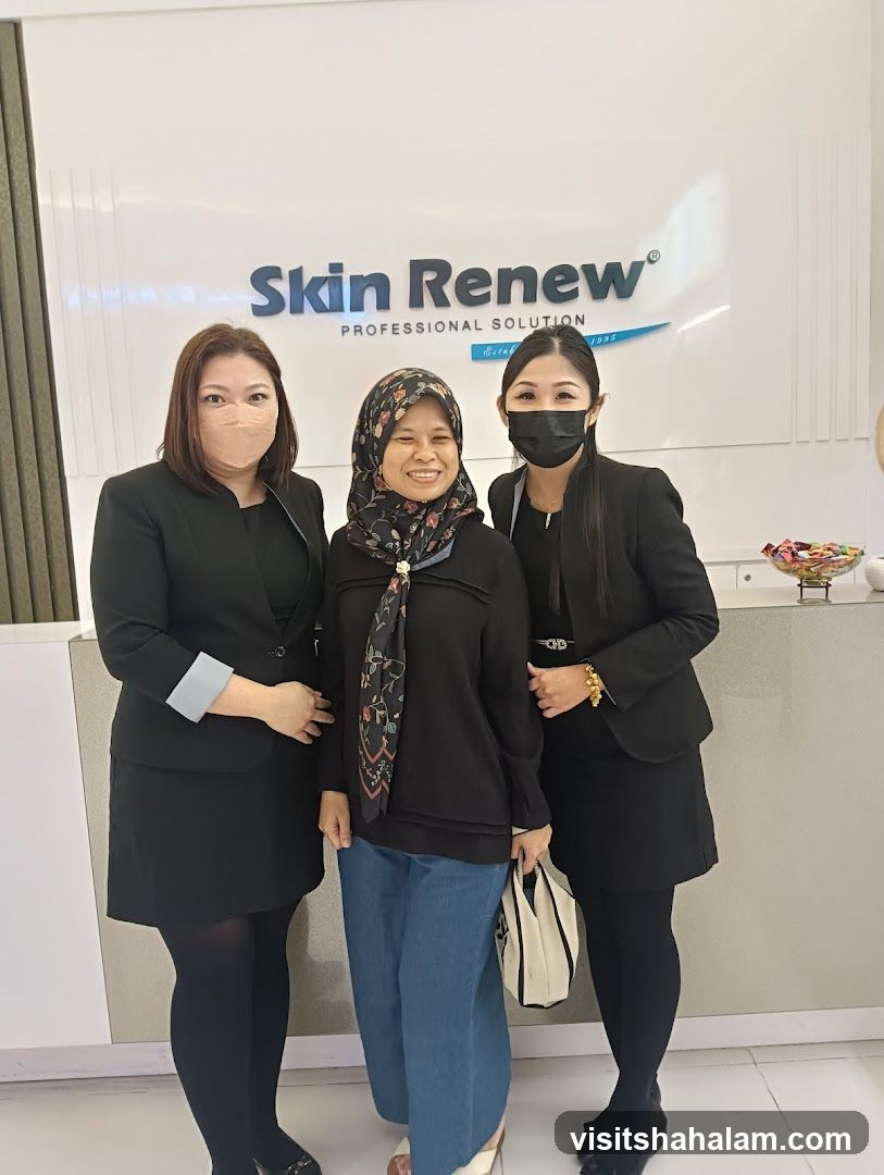 Three women posing in front of a sign