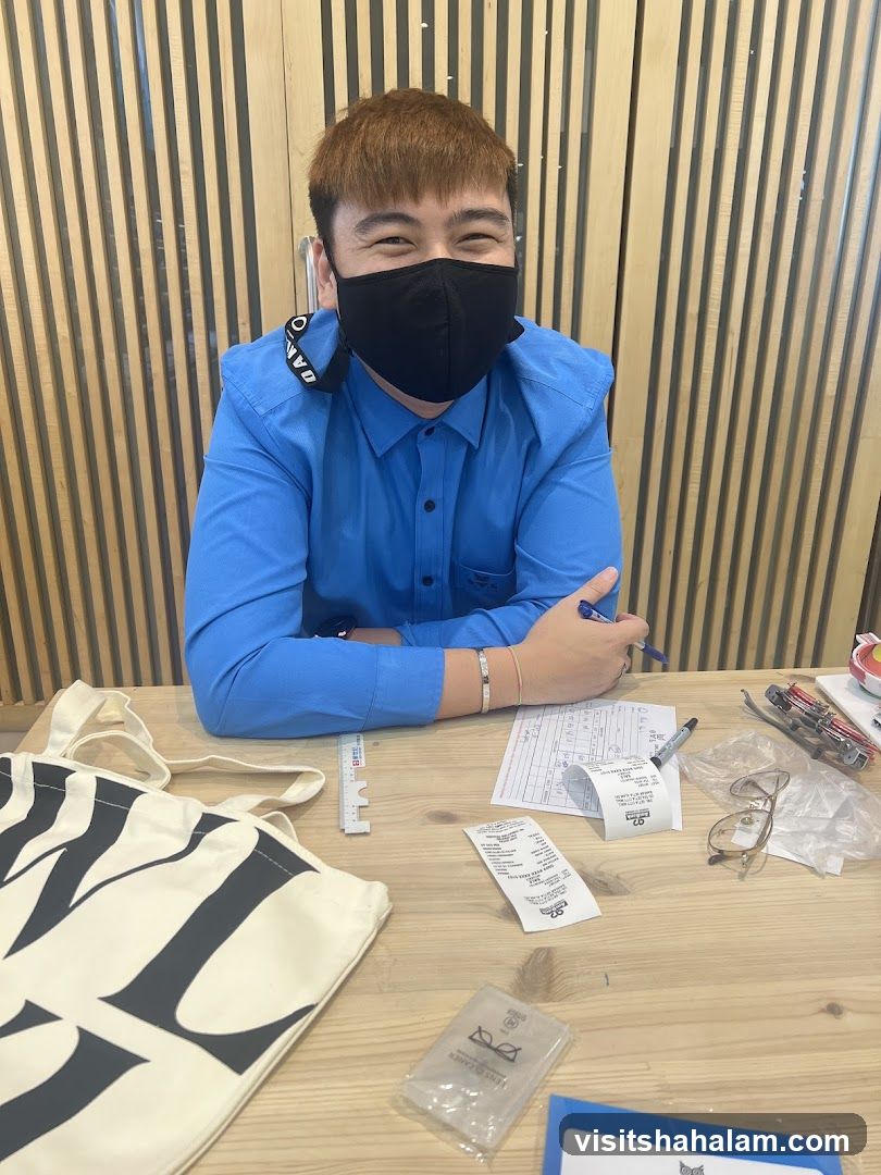 Man at a desk with a tote bag and receipts