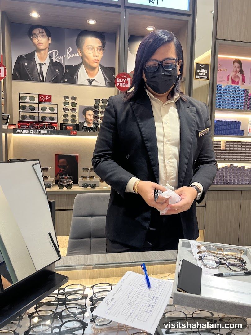 Optician assisting customer