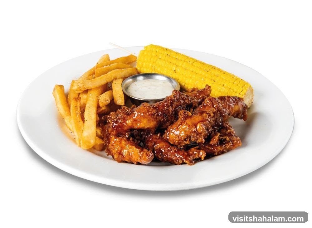 Chicken tenders with fries and corn on the cob