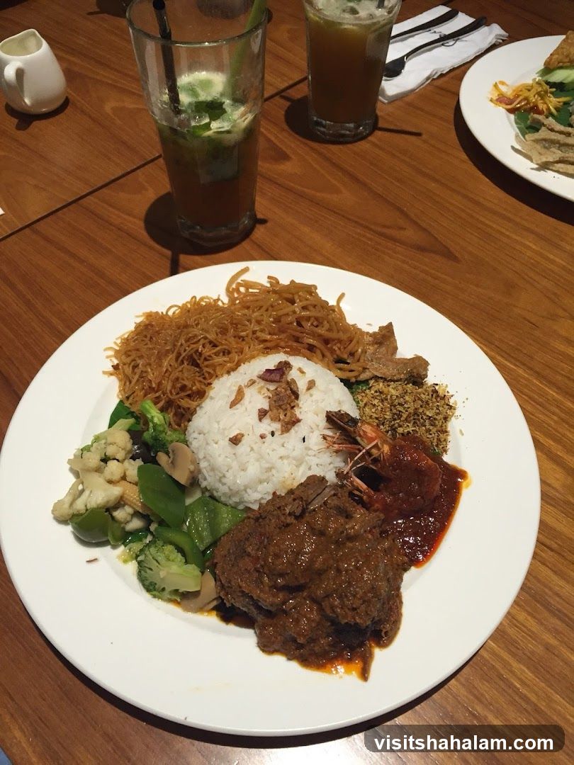 Plate of food with rice, meat, vegetables, and shrimp