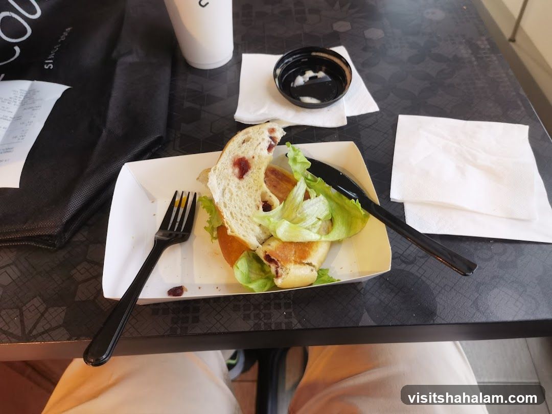 Half-eaten sandwich on a tray