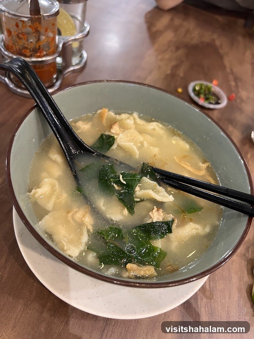 Bowl of Soup with Dumplings and Greens