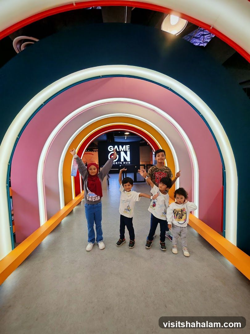 Children posing in a colorful arcade