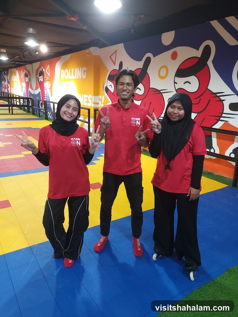 Three smiling people in red shirts
