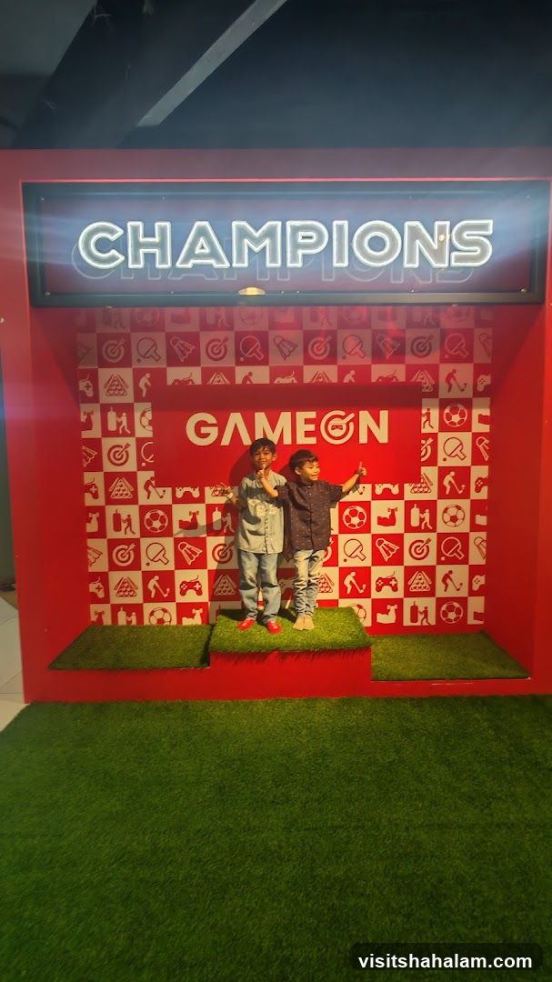 Children on a podium with "Champions" and "Game On" signs