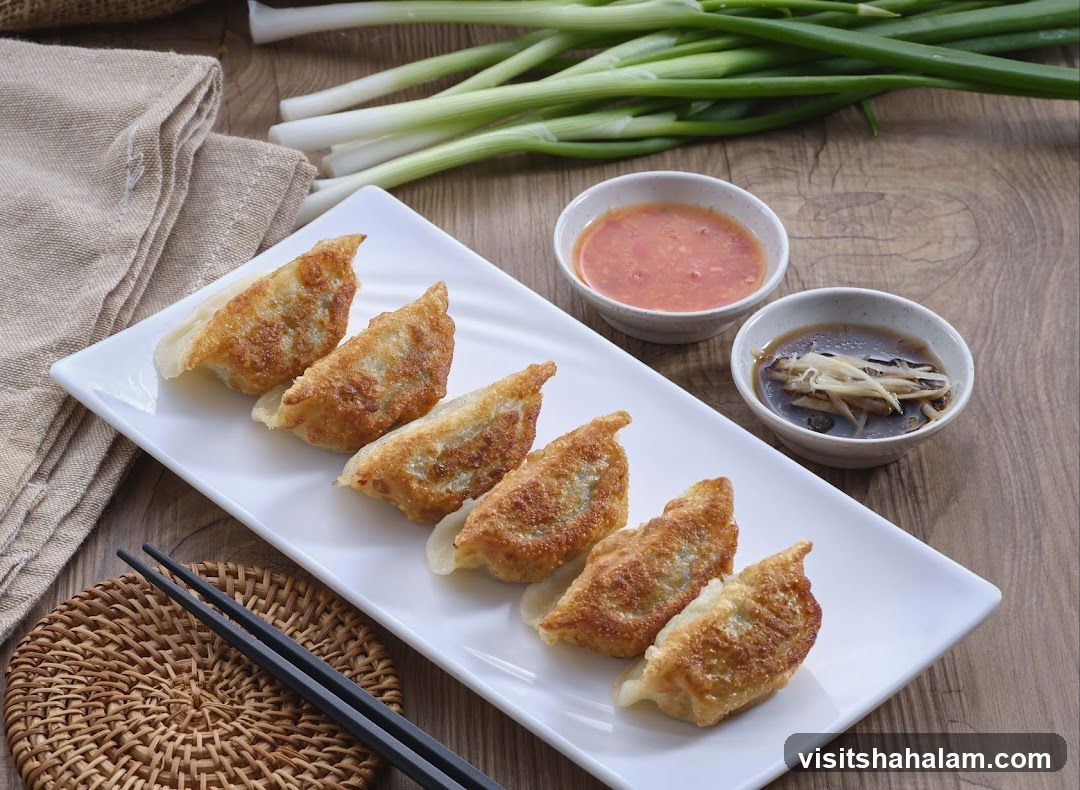 Pan-fried dumplings with dipping sauces