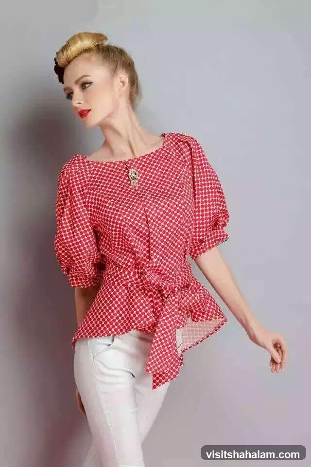 Woman in polka dot blouse and white pants