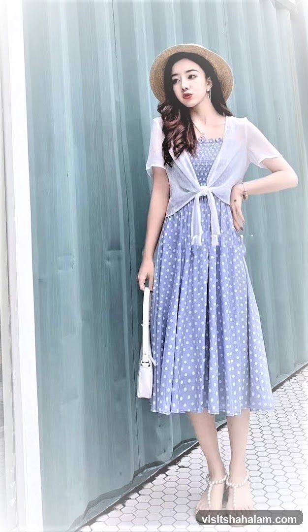 Woman in polka dot dress and straw hat