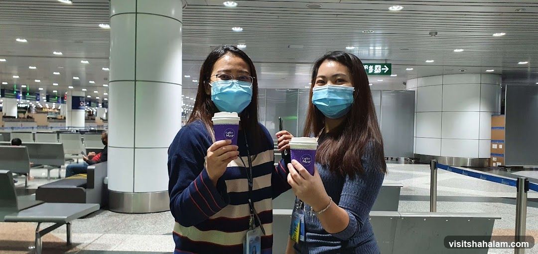 Two women holding coffee cups