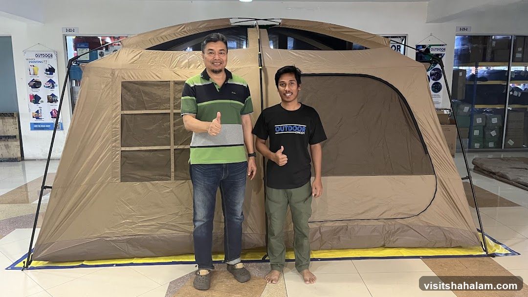 Two Men Posing in Front of a Large Tent