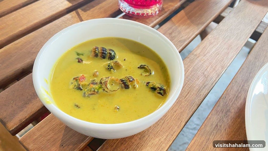 Bowl of Escargot in Yellow Sauce