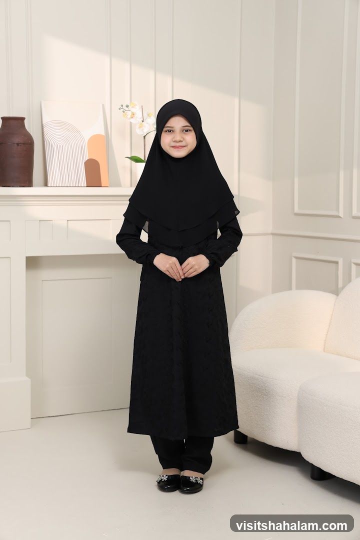 Young girl in black hijab and dress