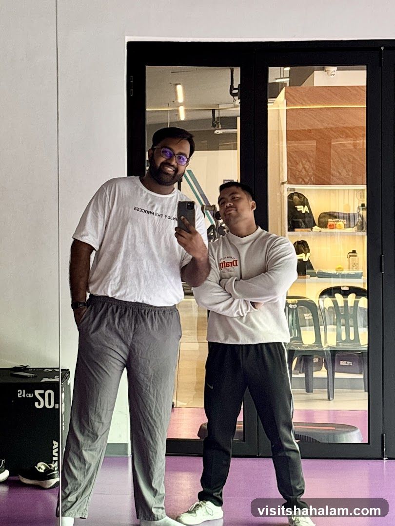 Two men taking a mirror selfie in a gym