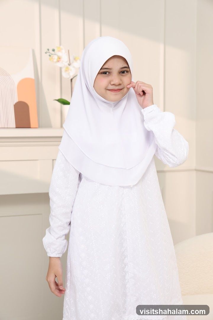 Young girl in white hijab and dress