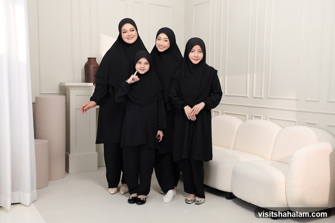 Four women in black hijabs and matching outfits
