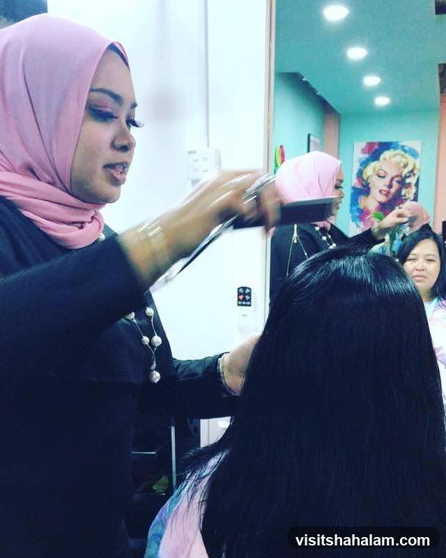 Hairdresser styling client's hair