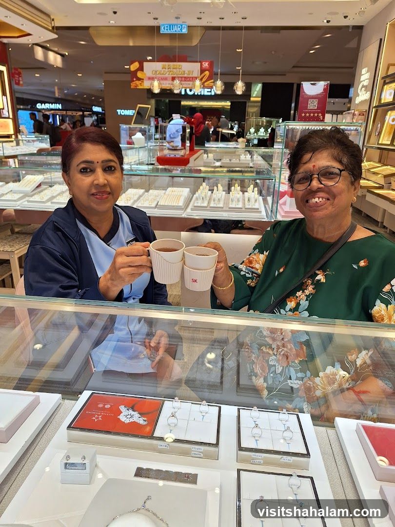 Two women enjoying drinks in a jewelry store