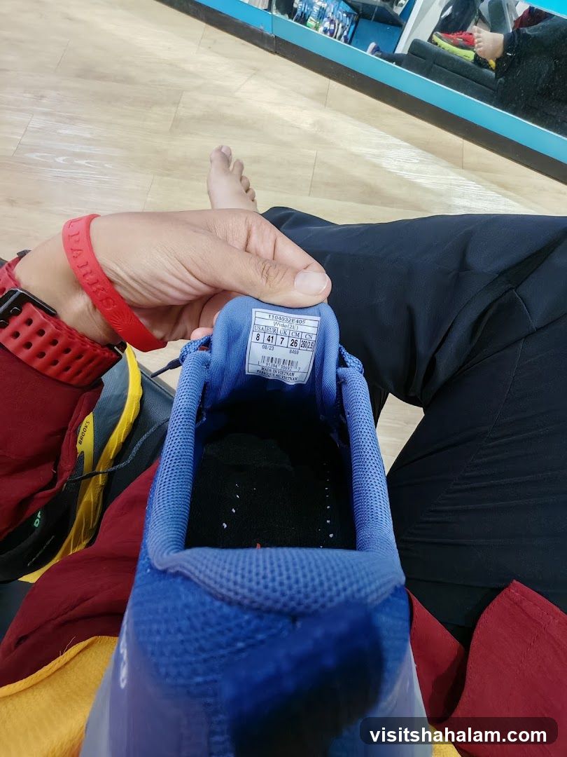 Person holding a blue running shoe